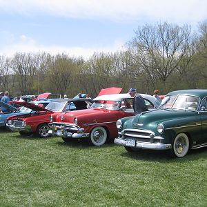 some family cars at a show together